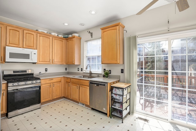 kitchen with a sink, light countertops, visible vents, and stainless steel appliances