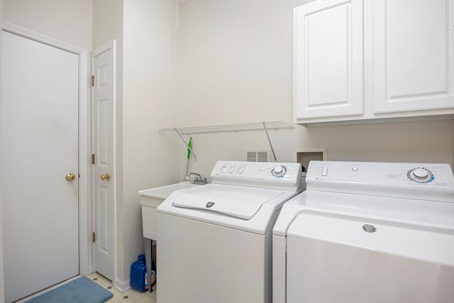 laundry area with washer and dryer and cabinet space