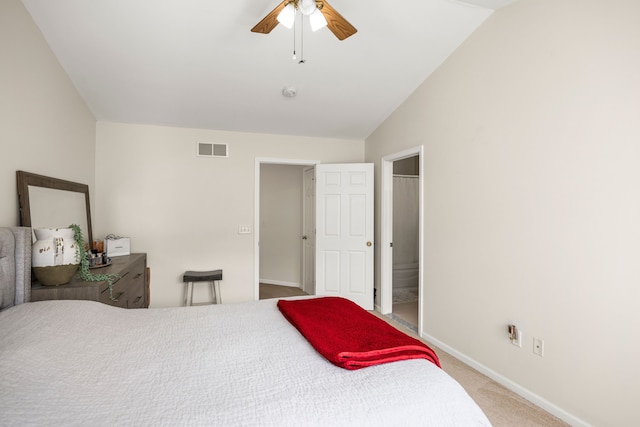 carpeted bedroom with vaulted ceiling, baseboards, visible vents, and ceiling fan