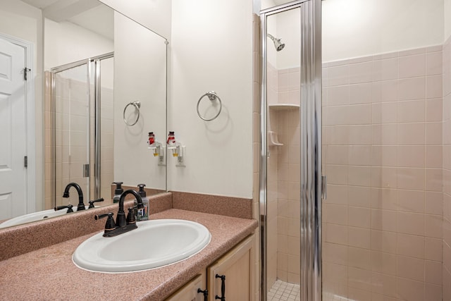 full bath with vanity and a shower stall