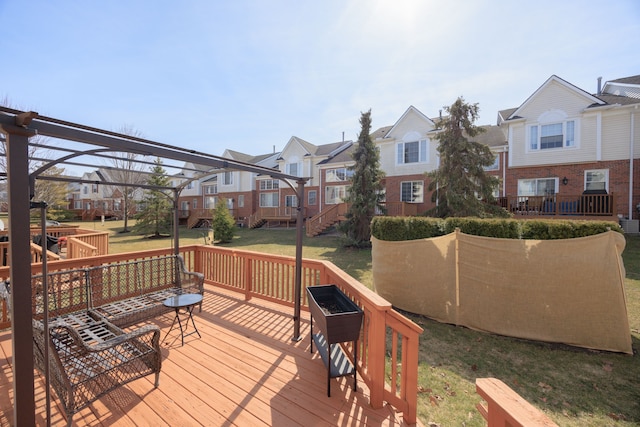 wooden deck featuring a yard and a residential view