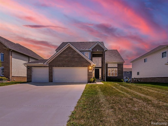 traditional-style home with brick siding, a garage, a front lawn, and driveway