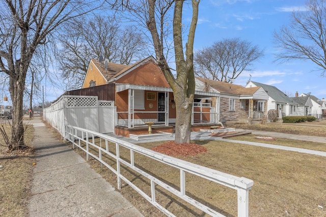 view of front of home featuring a porch and fence