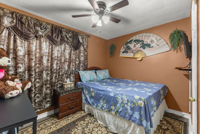 bedroom with baseboards, a textured ceiling, and ceiling fan