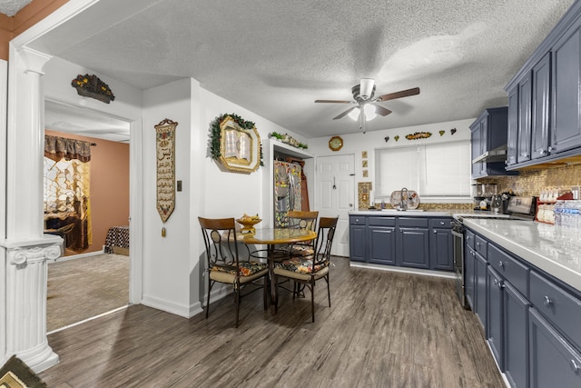 kitchen featuring dark wood finished floors, light countertops, stainless steel range with electric cooktop, blue cabinets, and a ceiling fan