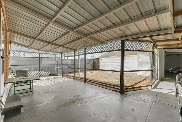 view of patio featuring cooling unit, an outdoor structure, and fence