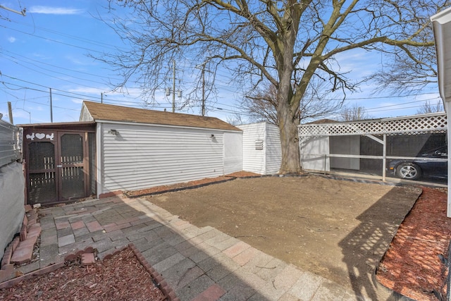 exterior space with fence and a shed