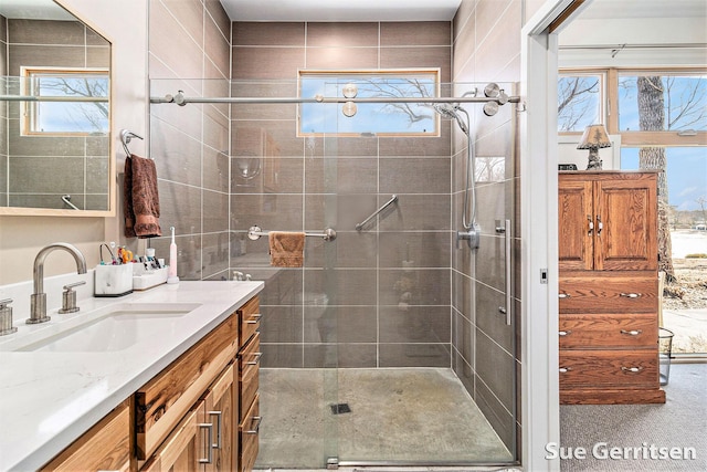 bathroom featuring a stall shower and vanity