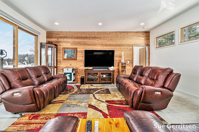 living area with recessed lighting, baseboards, and wooden walls