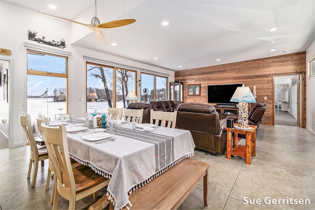 dining area with recessed lighting, wooden walls, and a healthy amount of sunlight