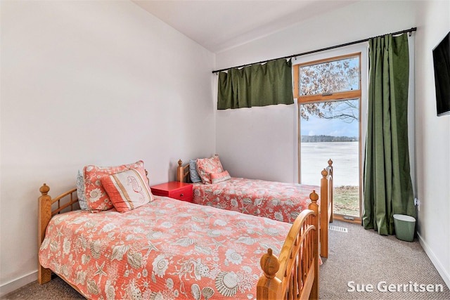 bedroom featuring baseboards, carpet, and vaulted ceiling