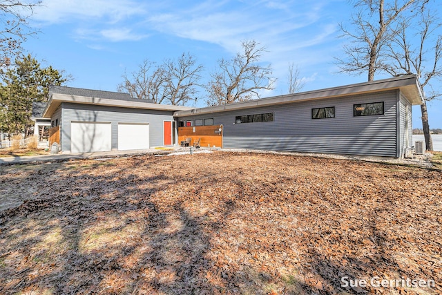 view of front of home with aphalt driveway and a garage