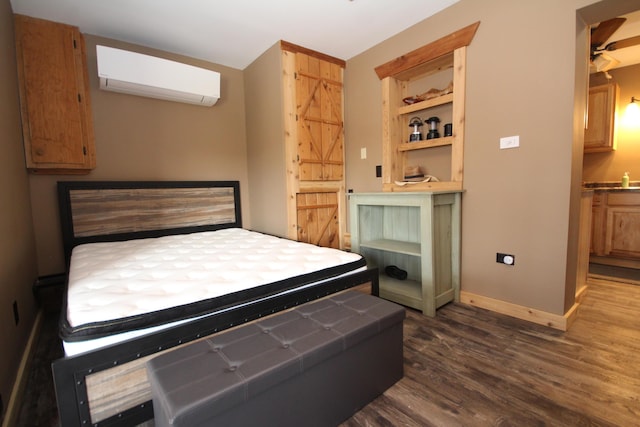 bedroom featuring dark wood finished floors, an AC wall unit, and baseboards