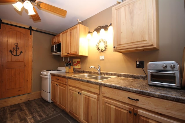 kitchen featuring a sink, stainless steel microwave, white electric range oven, a barn door, and a toaster