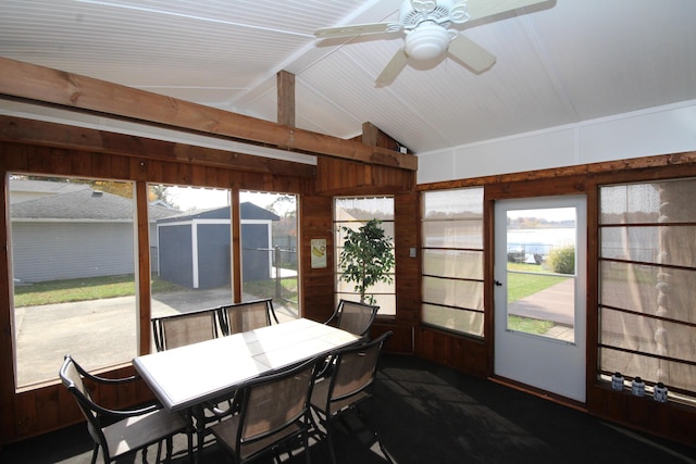 sunroom featuring a ceiling fan and vaulted ceiling with beams