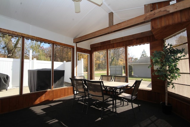 sunroom featuring a wealth of natural light, lofted ceiling with beams, and a ceiling fan