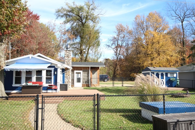 exterior space featuring a front lawn, a gate, fence private yard, and a chimney