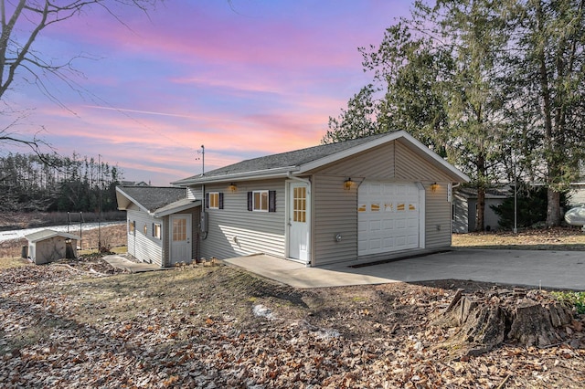 view of front of home with concrete driveway and a garage