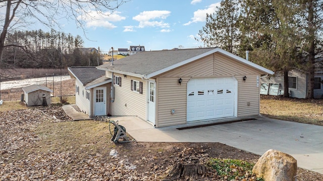 view of front of home with a garage, roof with shingles, an outdoor structure, and driveway