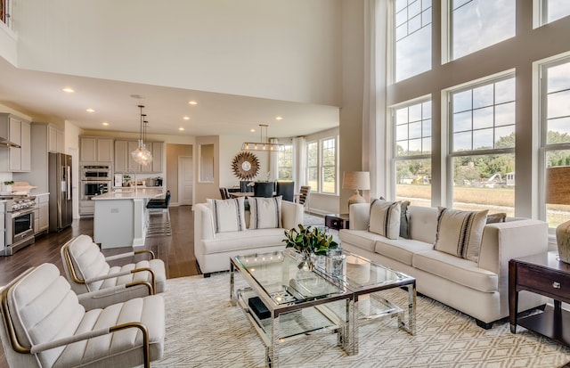 living room featuring recessed lighting, a high ceiling, and dark wood-style flooring