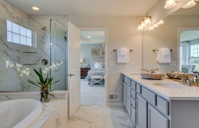 ensuite bathroom with visible vents, a marble finish shower, ensuite bath, a sink, and marble finish floor