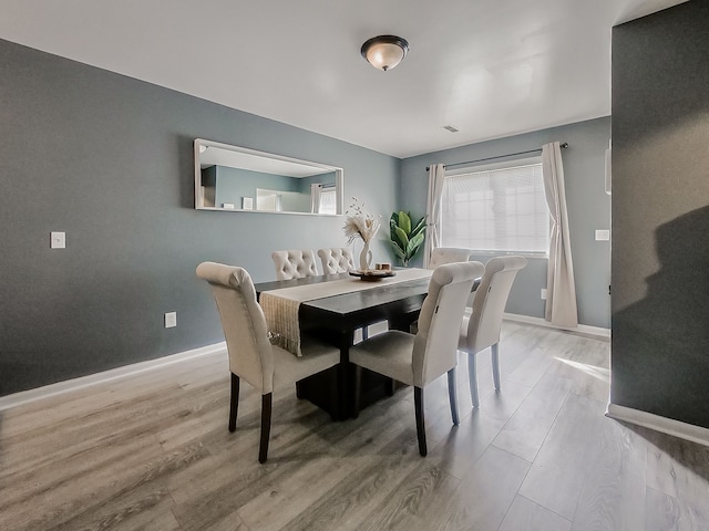 dining area featuring baseboards and wood finished floors