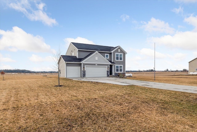 traditional-style home with stone siding, board and batten siding, concrete driveway, and a front yard