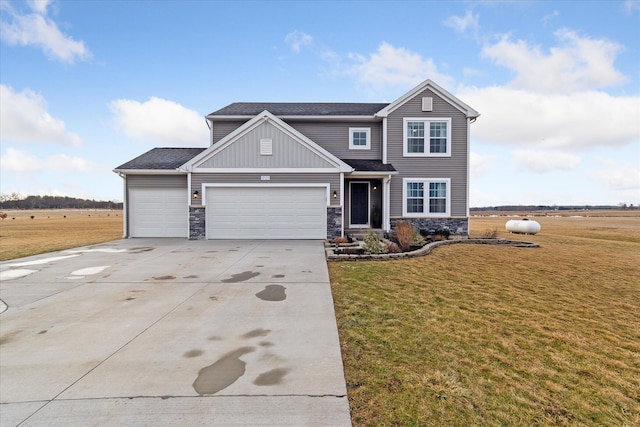 view of front of property featuring a front lawn, concrete driveway, a garage, and stone siding