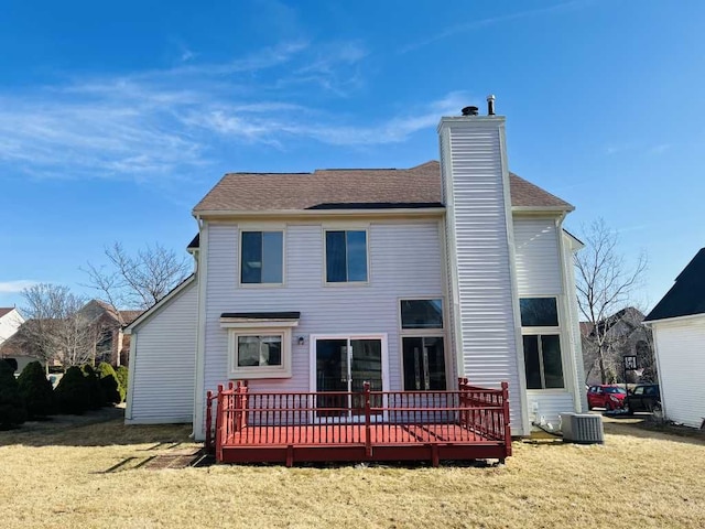 rear view of property featuring a wooden deck, central AC, a chimney, and a yard