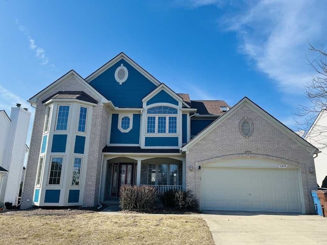 view of front of house with concrete driveway, a garage, and brick siding