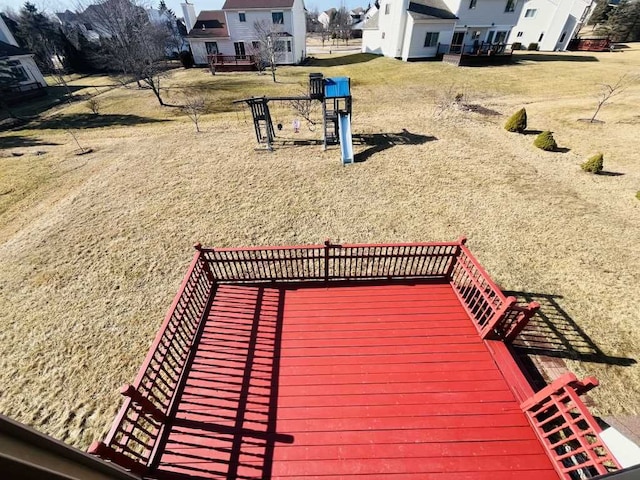 deck with a lawn and a playground