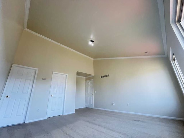 unfurnished bedroom with visible vents, baseboards, high vaulted ceiling, and carpet flooring