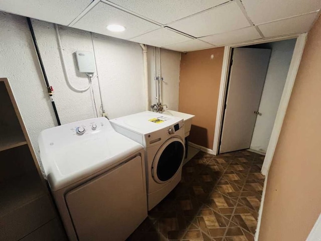 clothes washing area featuring a sink, laundry area, and washer and clothes dryer