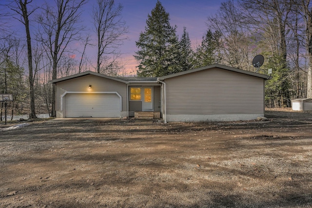 view of front of home featuring an attached garage, driveway, and entry steps