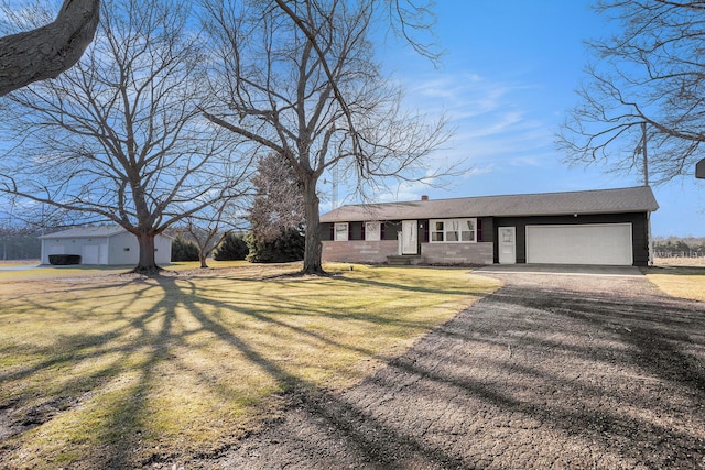 view of front facade featuring a garage, a front yard, a chimney, and driveway