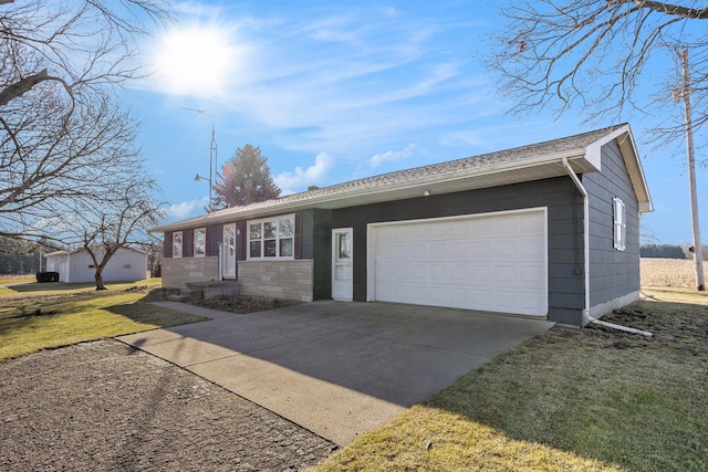 single story home featuring a garage, concrete driveway, and a front lawn