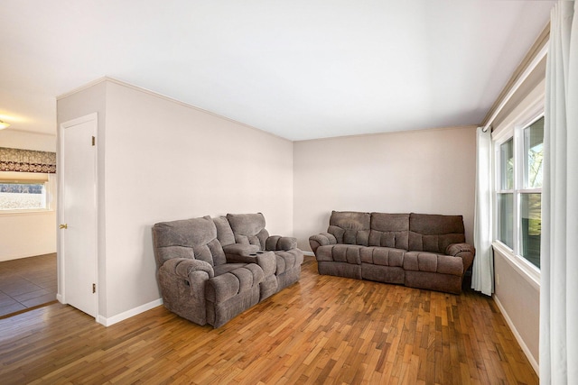 living room featuring baseboards and light wood finished floors