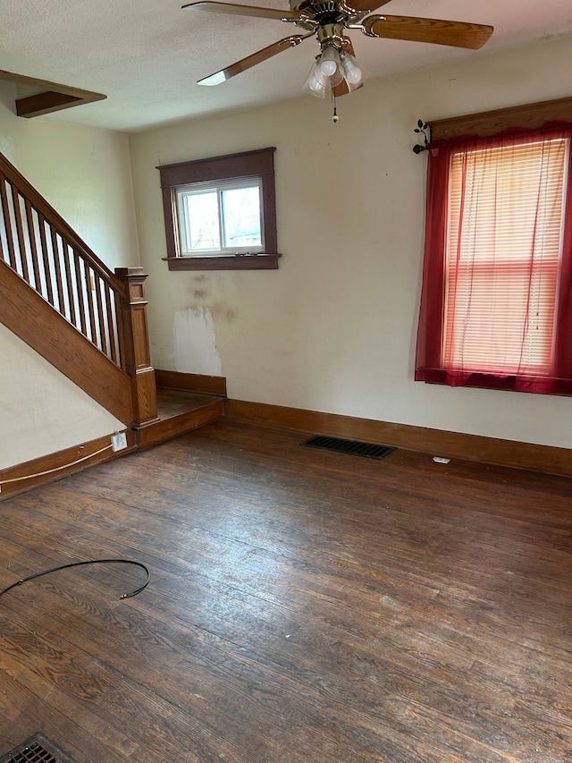 1406 W Ottawa St W, Lansing, MI 48915 - empty room with wood finished floors, stairway, ceiling fan, and baseboards