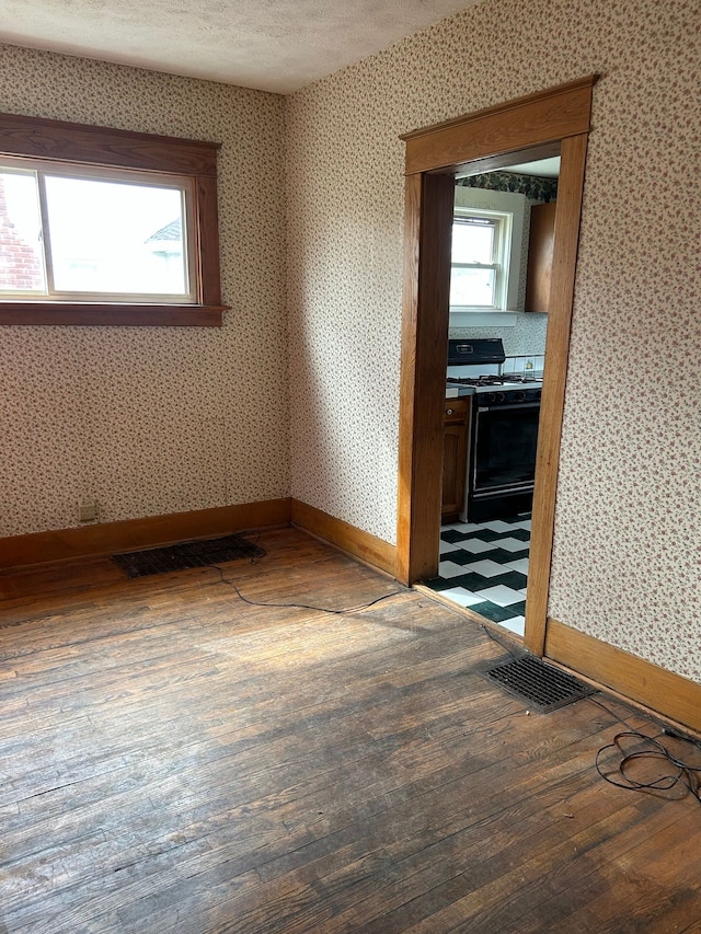 1406 W Ottawa St W, Lansing, MI 48915 - unfurnished room with hardwood / wood-style floors and baseboards
