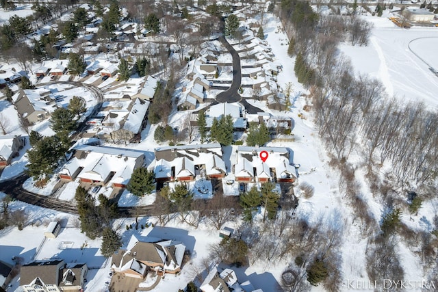 snowy aerial view with a residential view