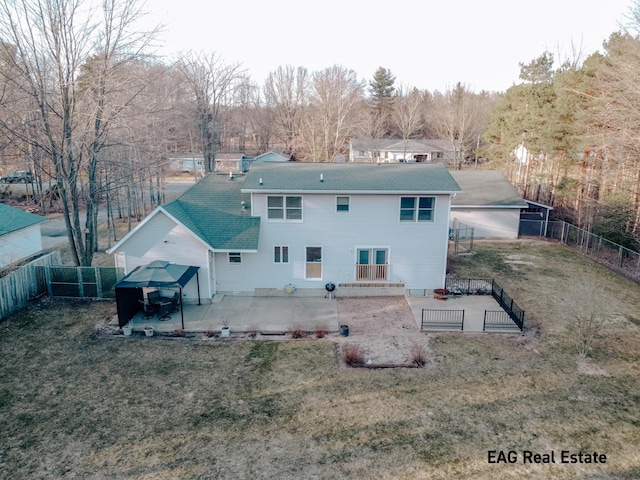 back of house featuring a patio, a yard, and a fenced backyard