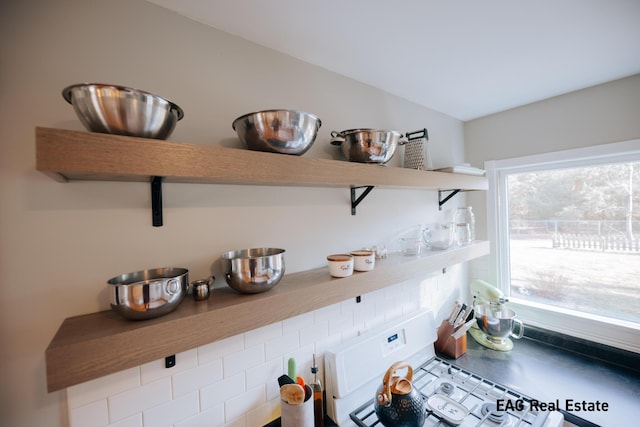 interior details featuring open shelves and white range with gas stovetop