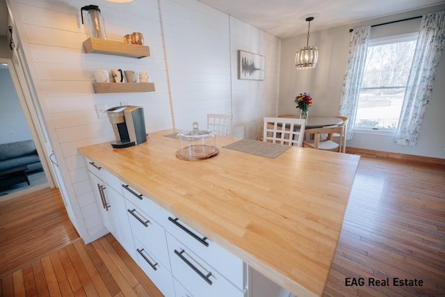 interior space with light wood finished floors and a notable chandelier