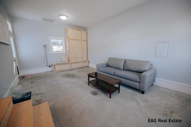 living room featuring baseboards, visible vents, and concrete floors