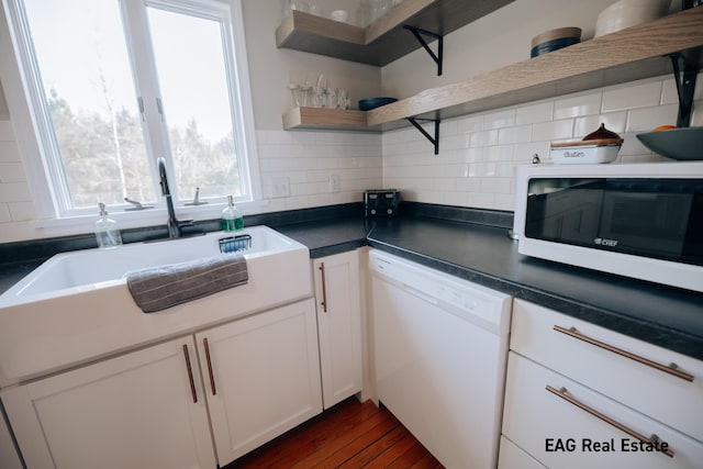 kitchen with tasteful backsplash, open shelves, white cabinets, white appliances, and a sink