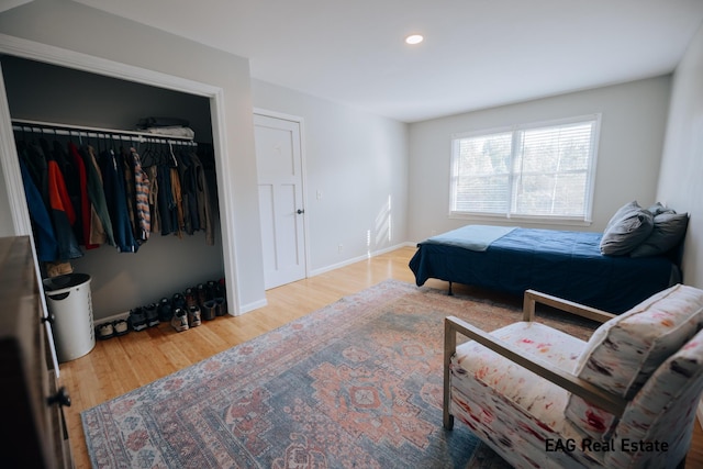 bedroom featuring recessed lighting, a closet, baseboards, and wood finished floors