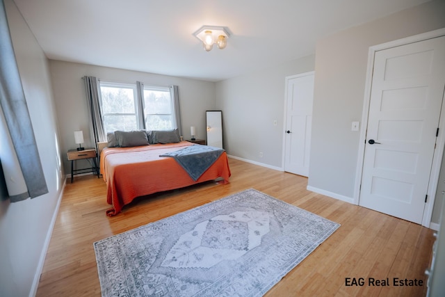 bedroom with baseboards and light wood-style floors