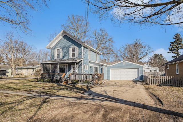 view of front of house with an outbuilding, a detached garage, and fence