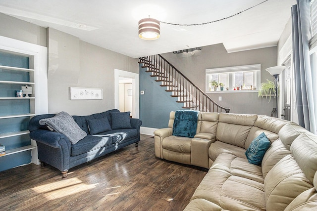 living room featuring dark wood-style floors and stairway