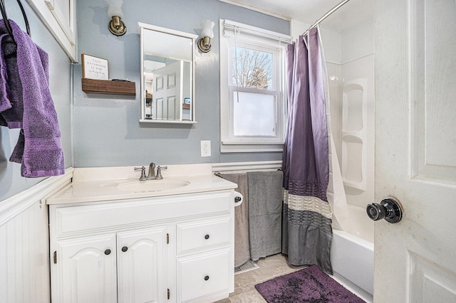 bathroom with wainscoting, vanity, and shower / bath combination with curtain